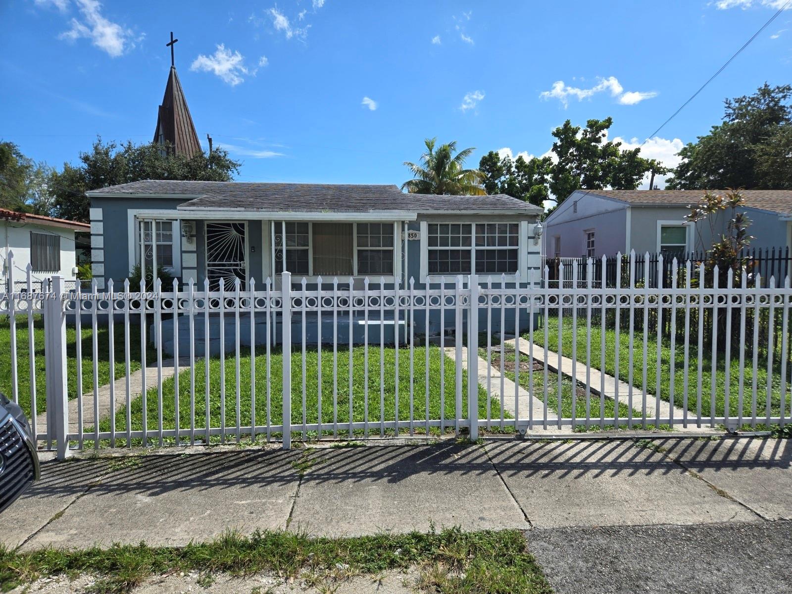 a view of a house with a small yard and plants