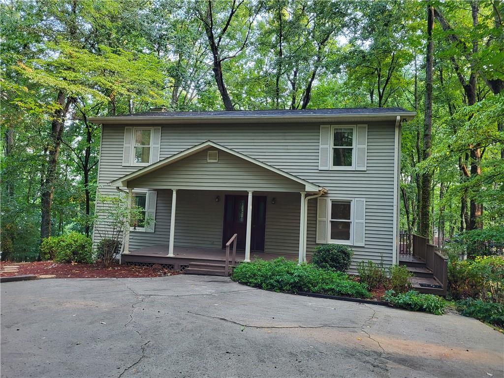 a front view of house with yard and trees