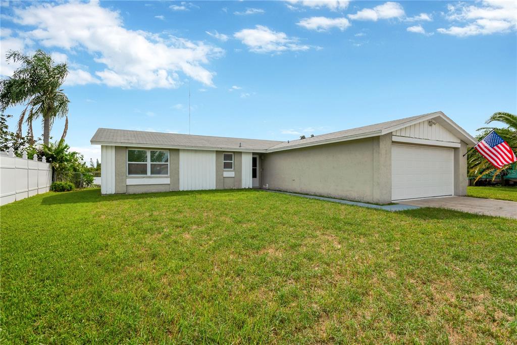 a view of an house with backyard space and garden