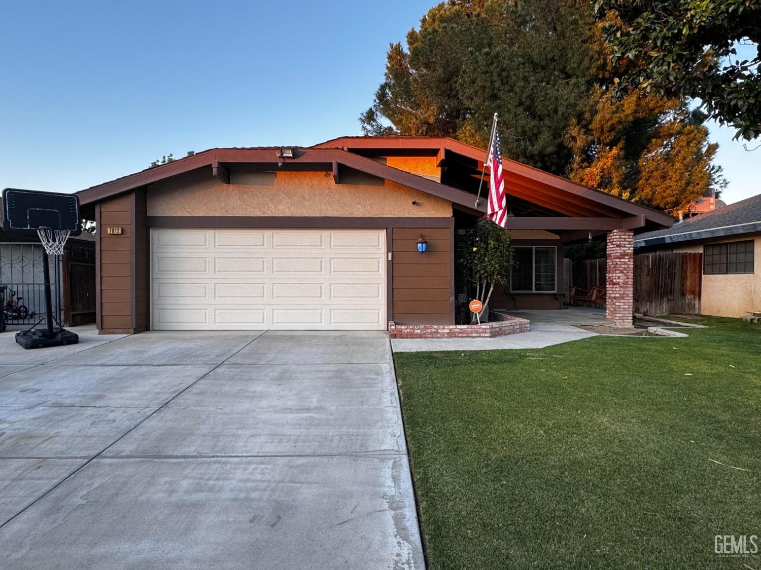 a view of a house with a yard and garage