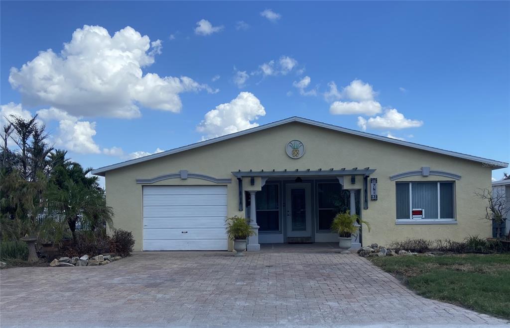 a view of a house with a yard and garage