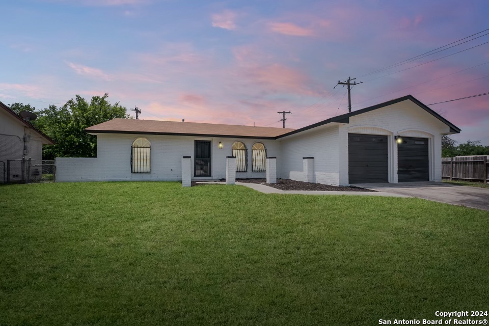 a view of a house with a backyard