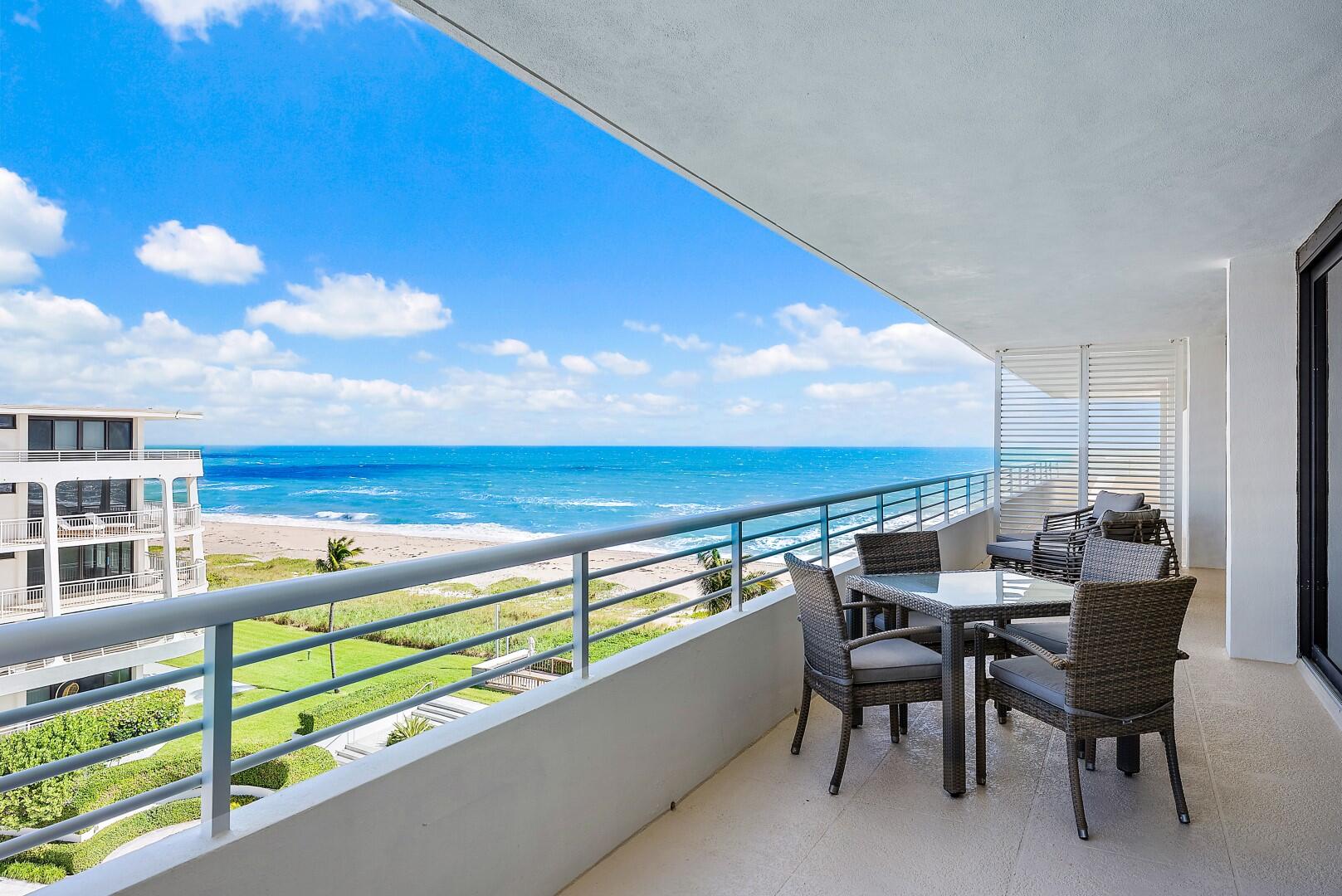 a roof deck with table and chairs and wooden floor