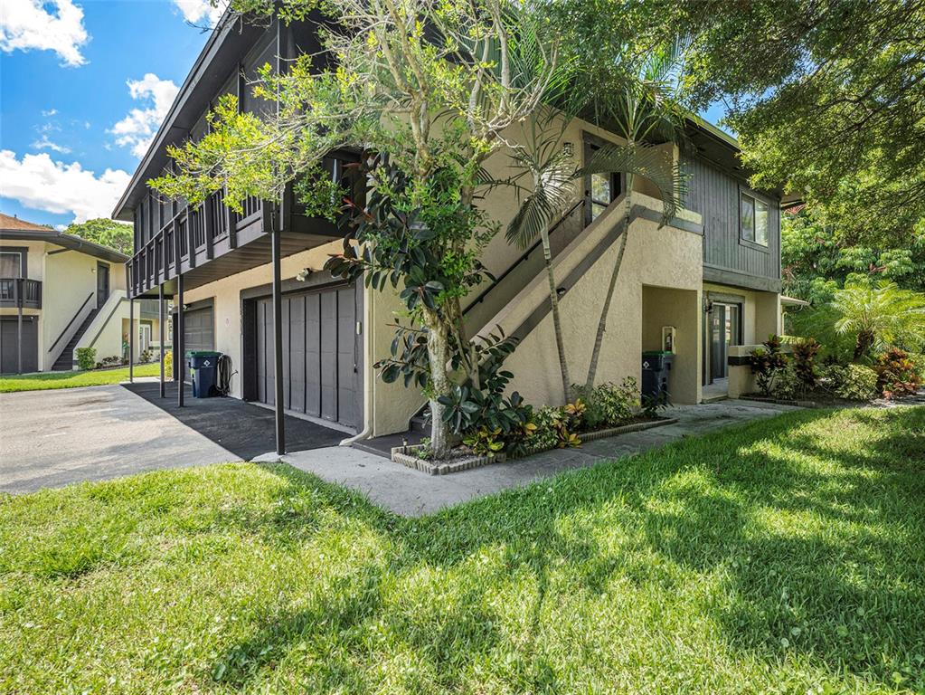 a view of a house with yard and tree s