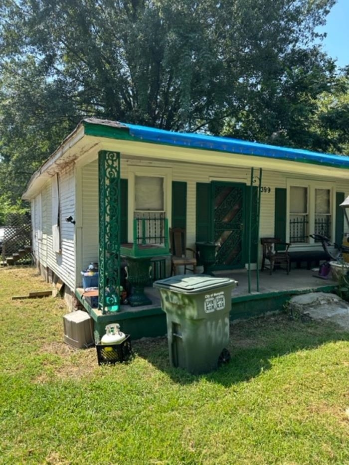 a view of a house with backyard sitting area and garden