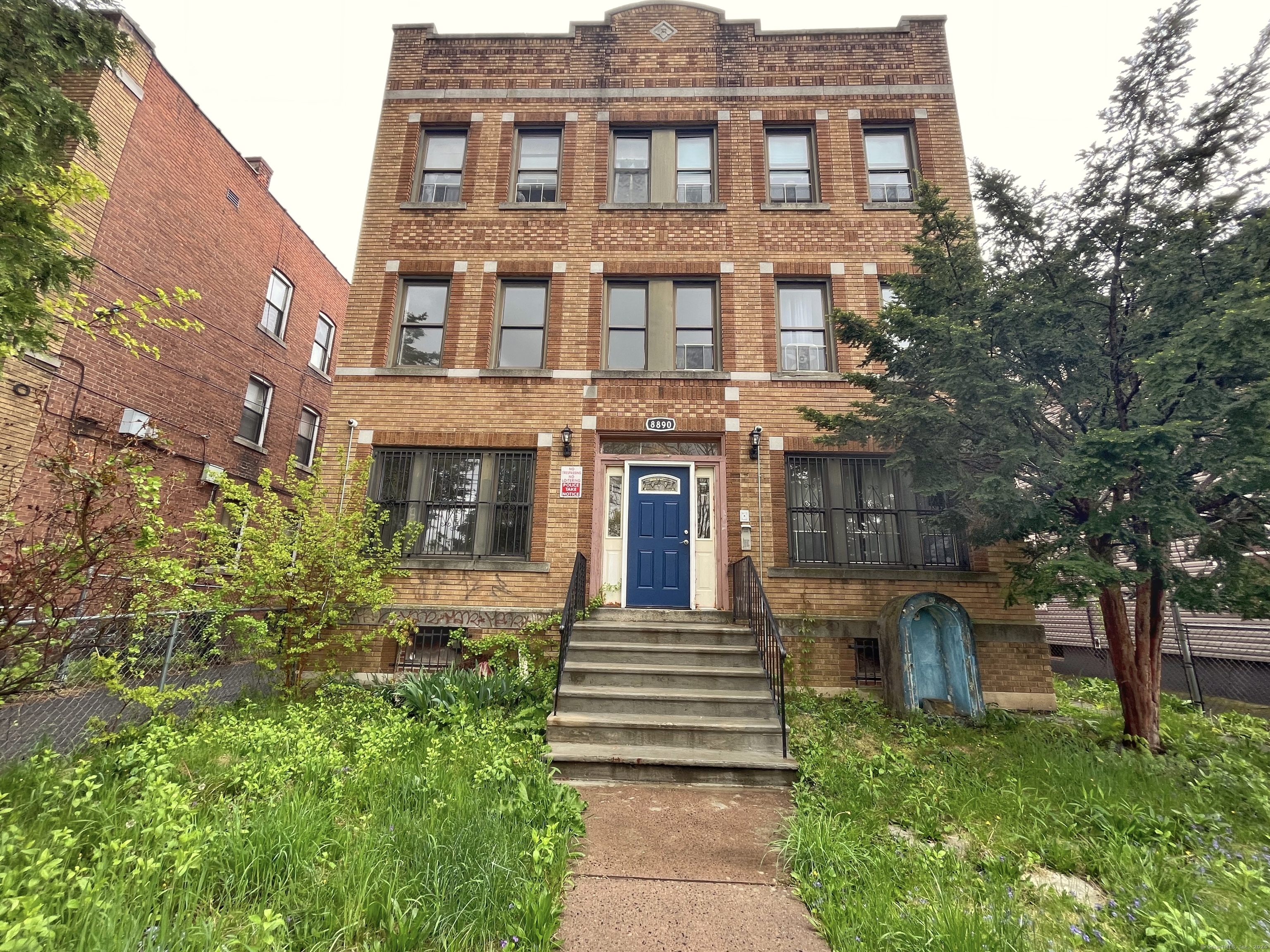 a front view of a residential apartment building with a yard