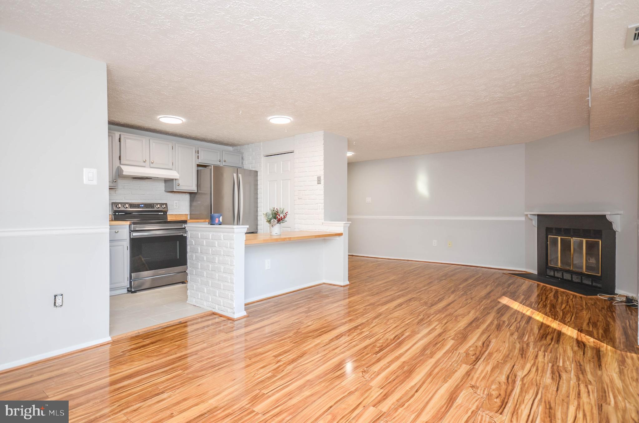 a kitchen with granite countertop a stove and cabinets