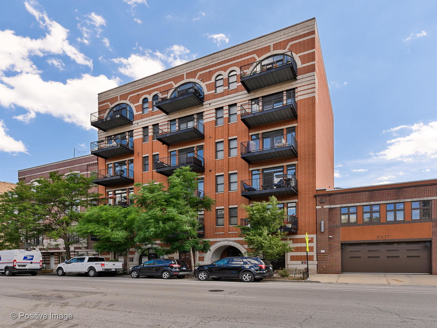 a front view of a building with parking