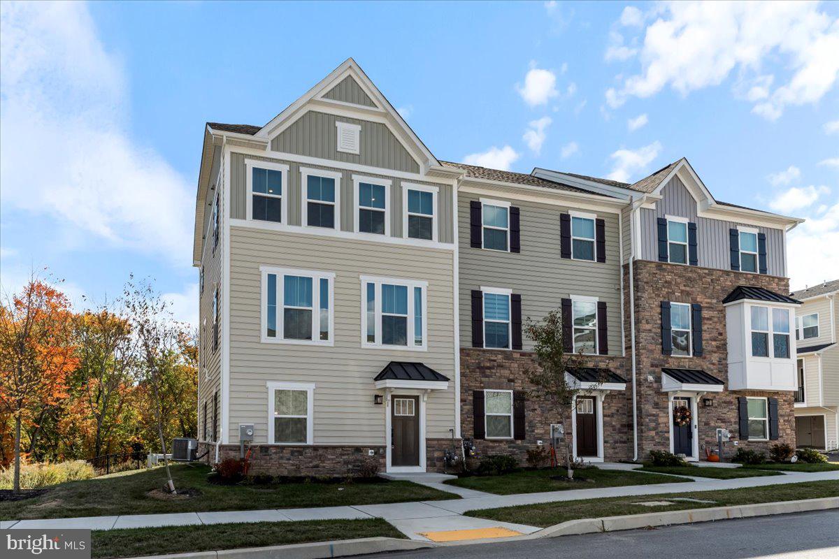 a front view of a residential apartment building with a yard