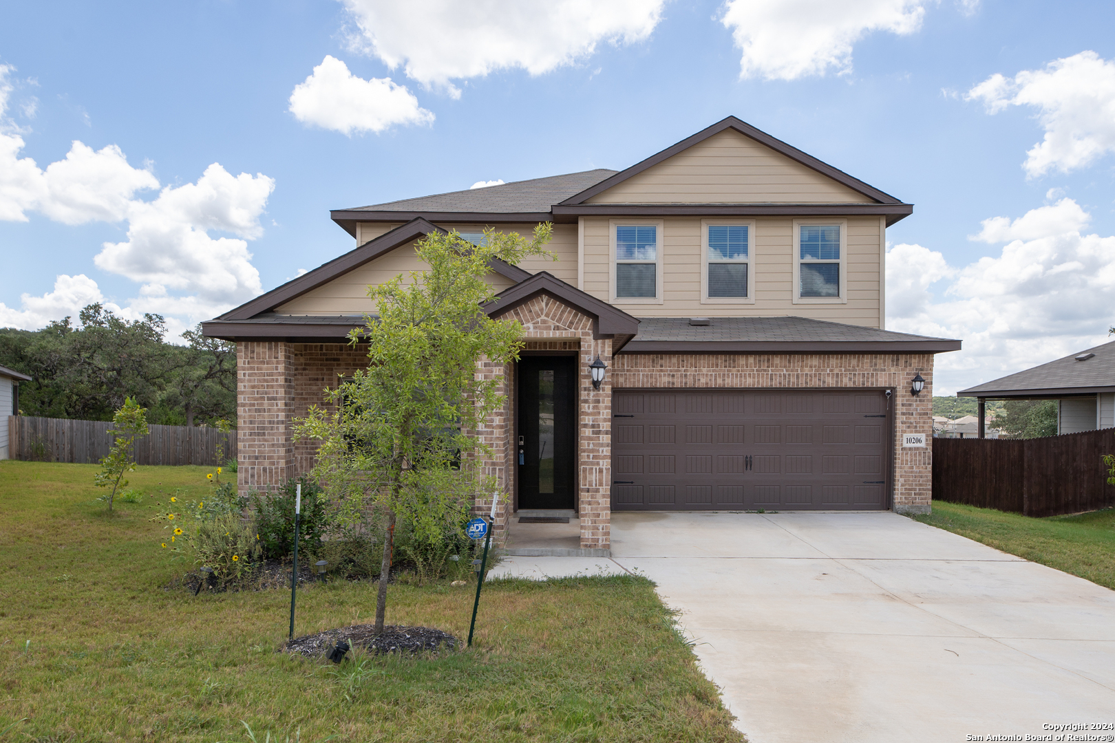 a front view of a house with a yard