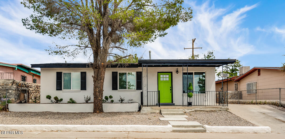 a view of a house with a tree in front