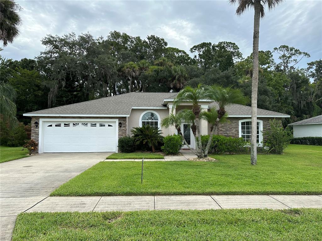 a front view of a house with a yard and garage