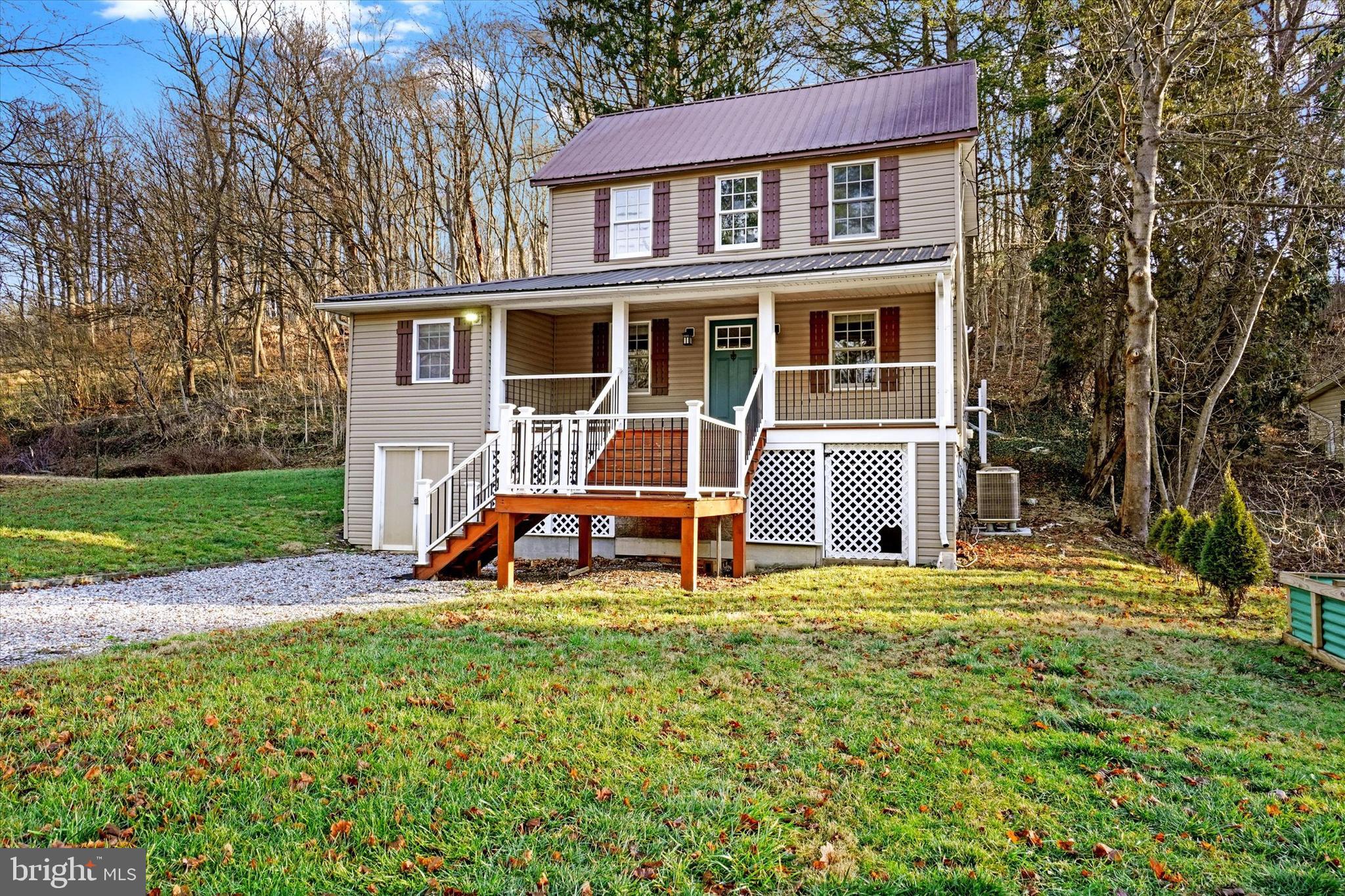 a view of a house with a yard and sitting area