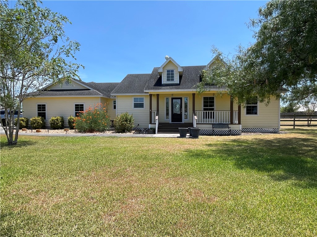 a front view of house with yard and green space