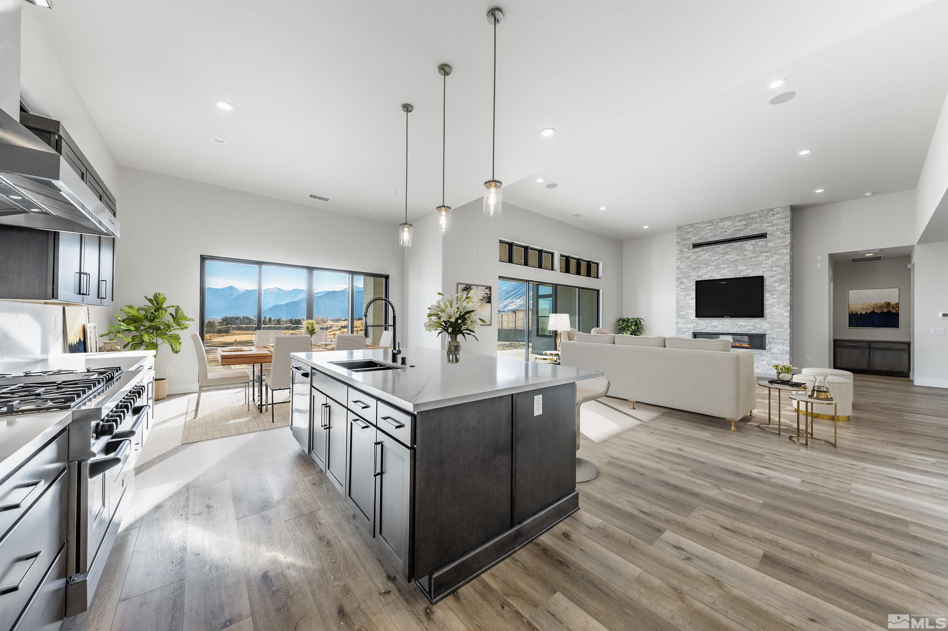 a kitchen with stainless steel appliances granite countertop a lot of cabinets and wooden floor