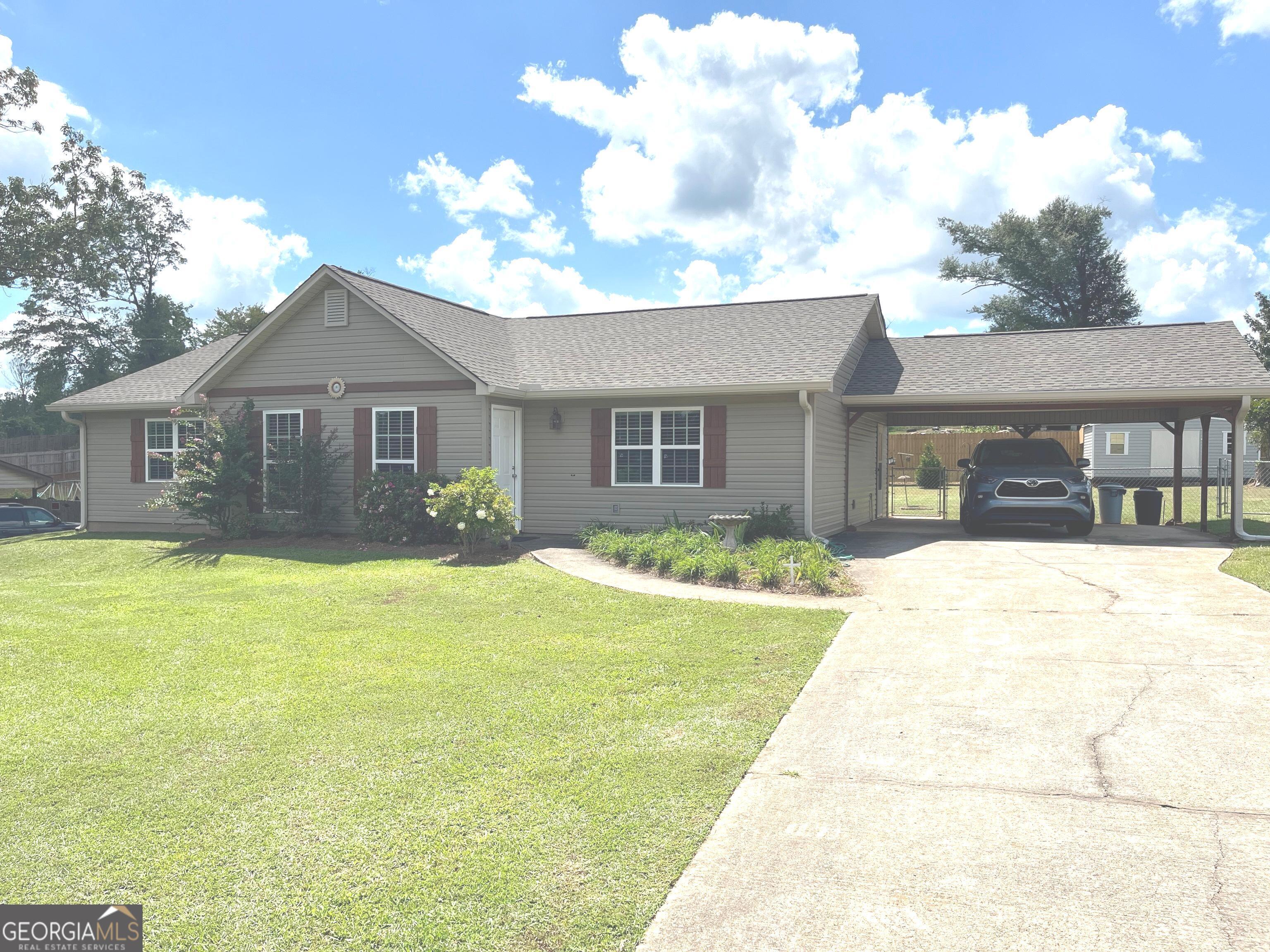 a front view of a house with a garden