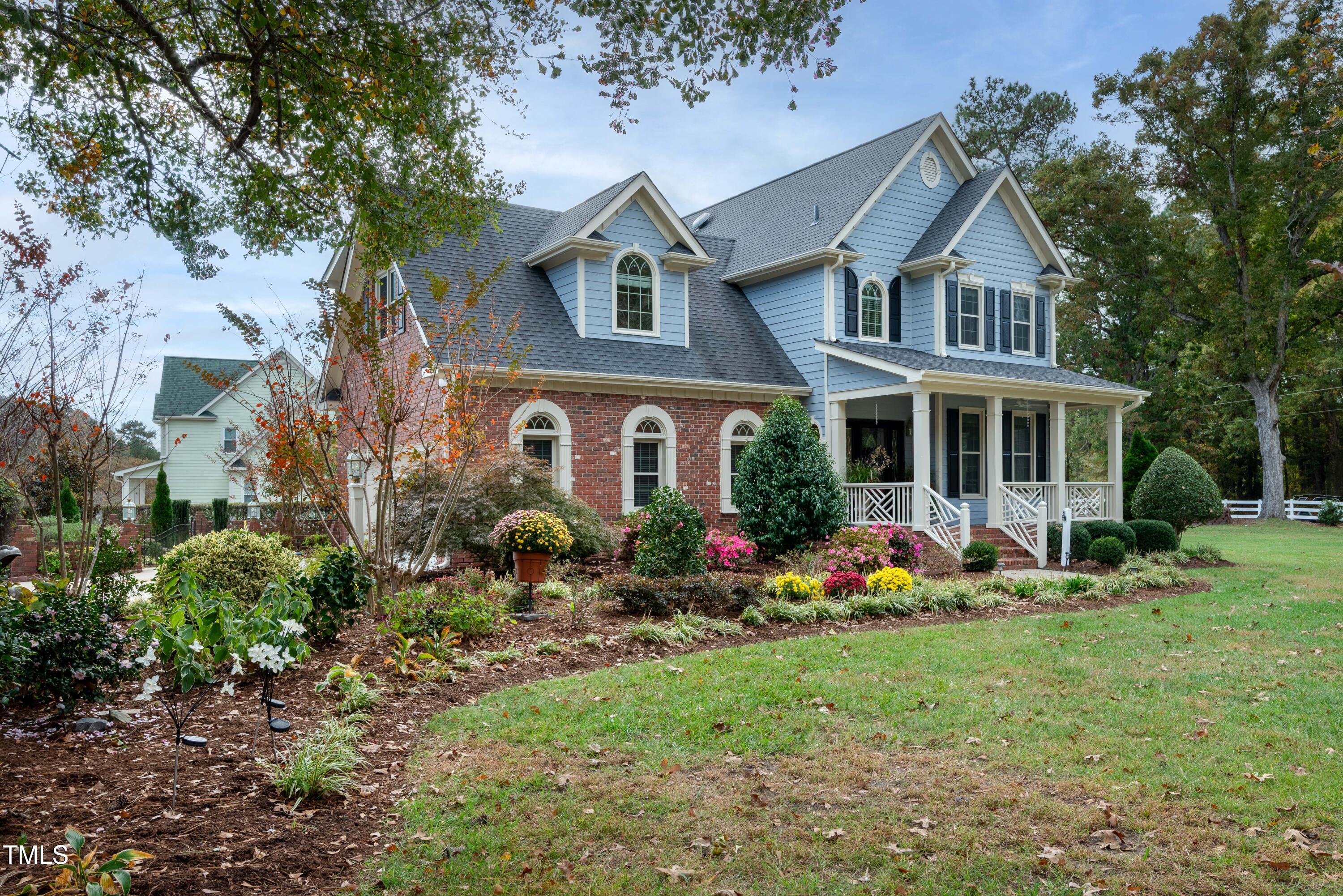 a front view of house with yard and trees around