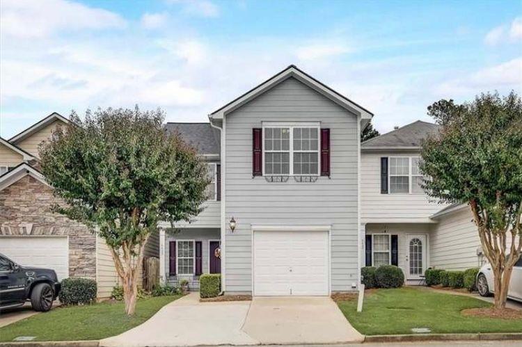 a front view of a house with a yard