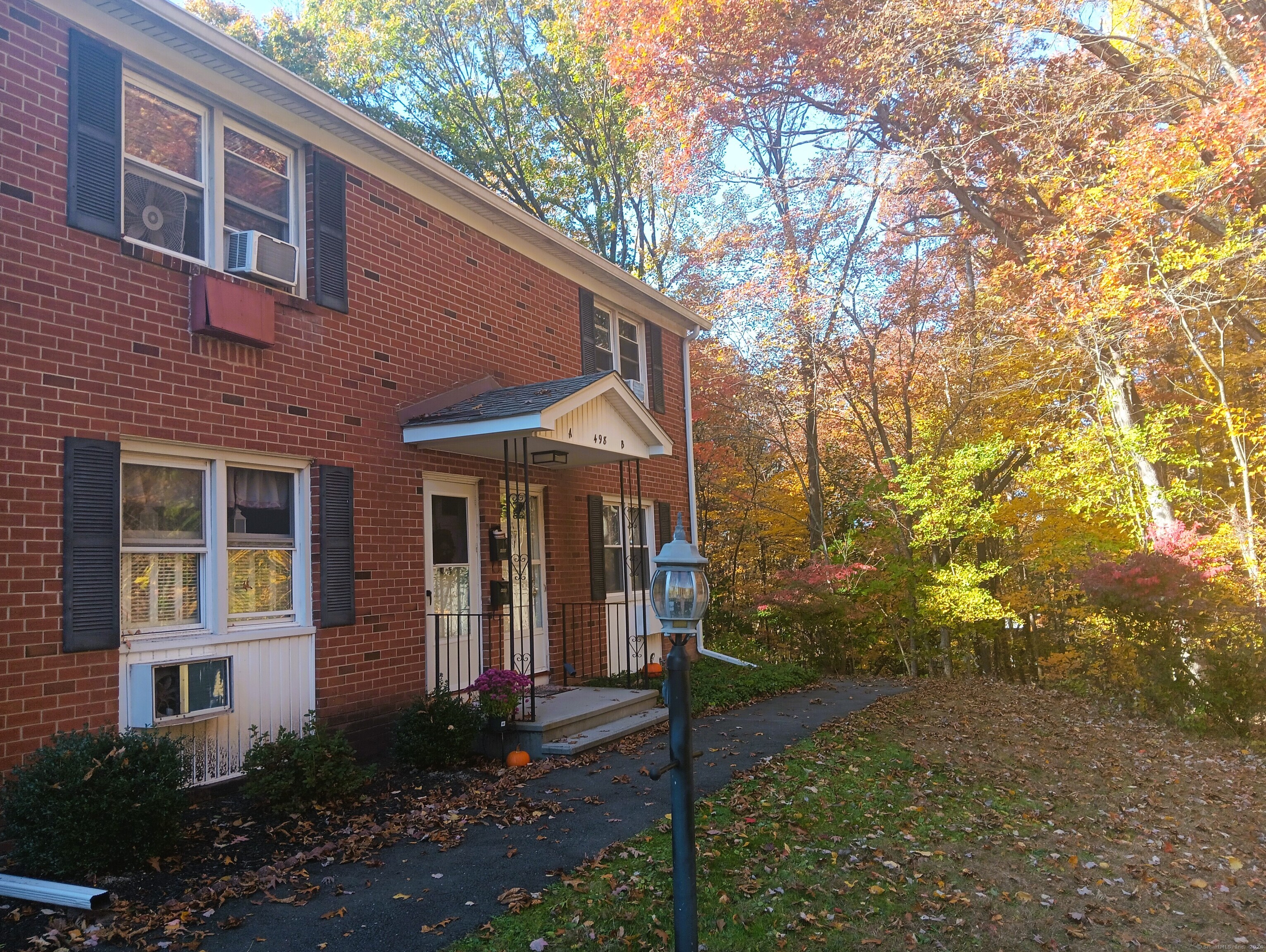 a front view of a house with yard and green space