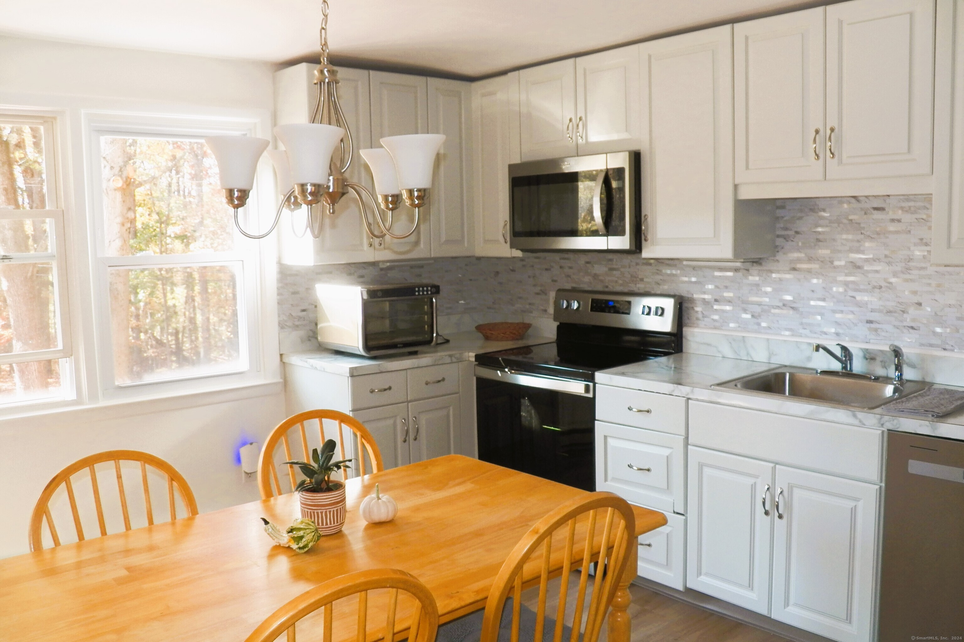 a kitchen with stainless steel appliances a stove a sink a microwave and cabinets