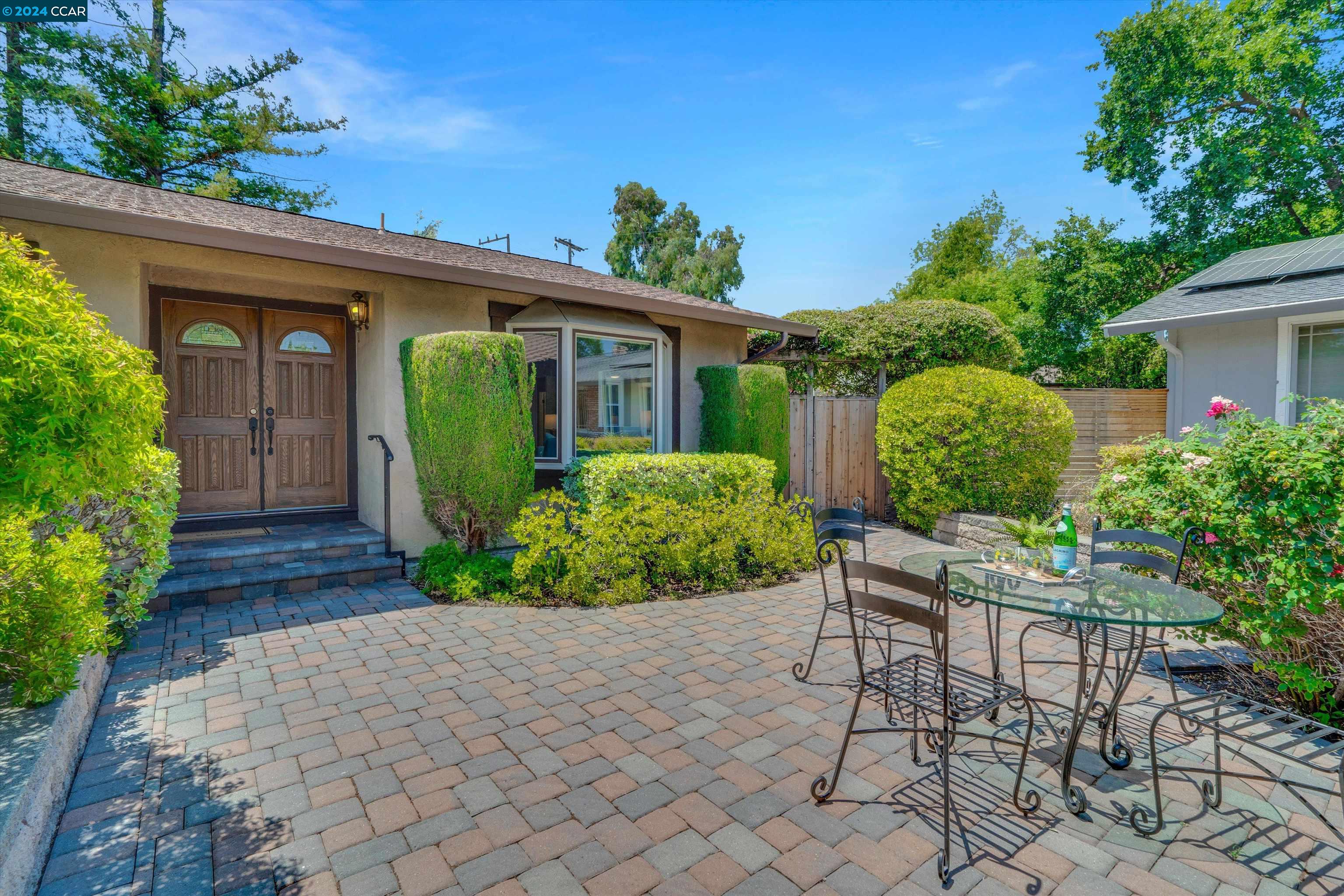 a view of a house with a chairs in a patio