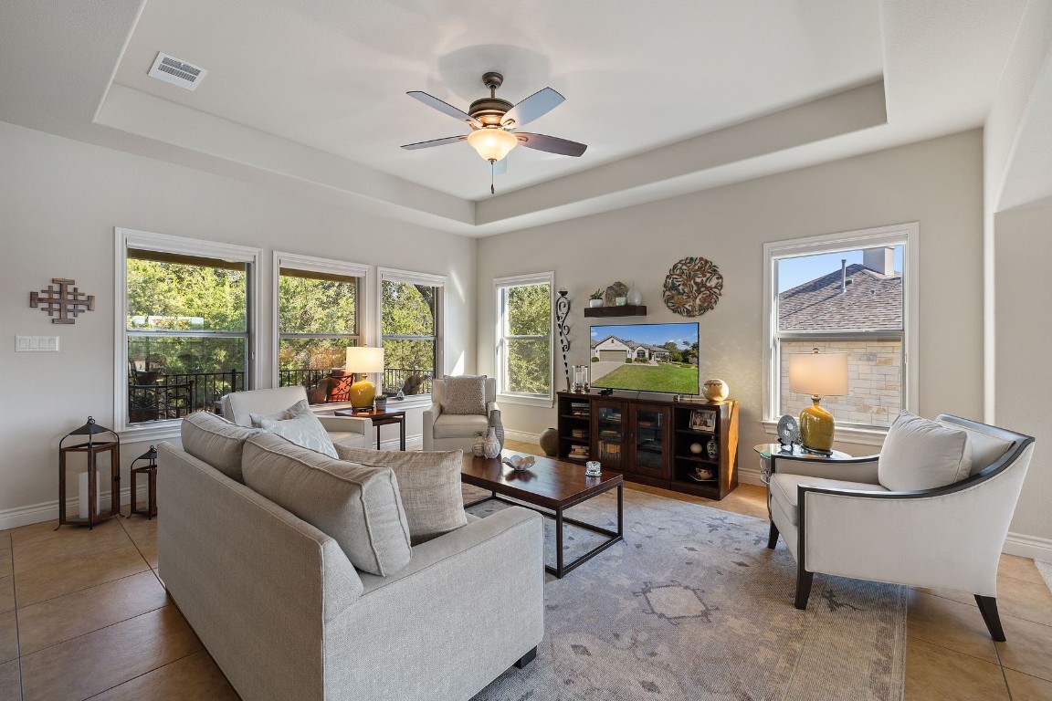 a living room with furniture a chandelier and a window