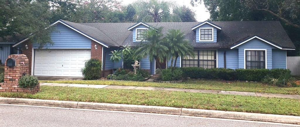 a view of a house with a yard and garage