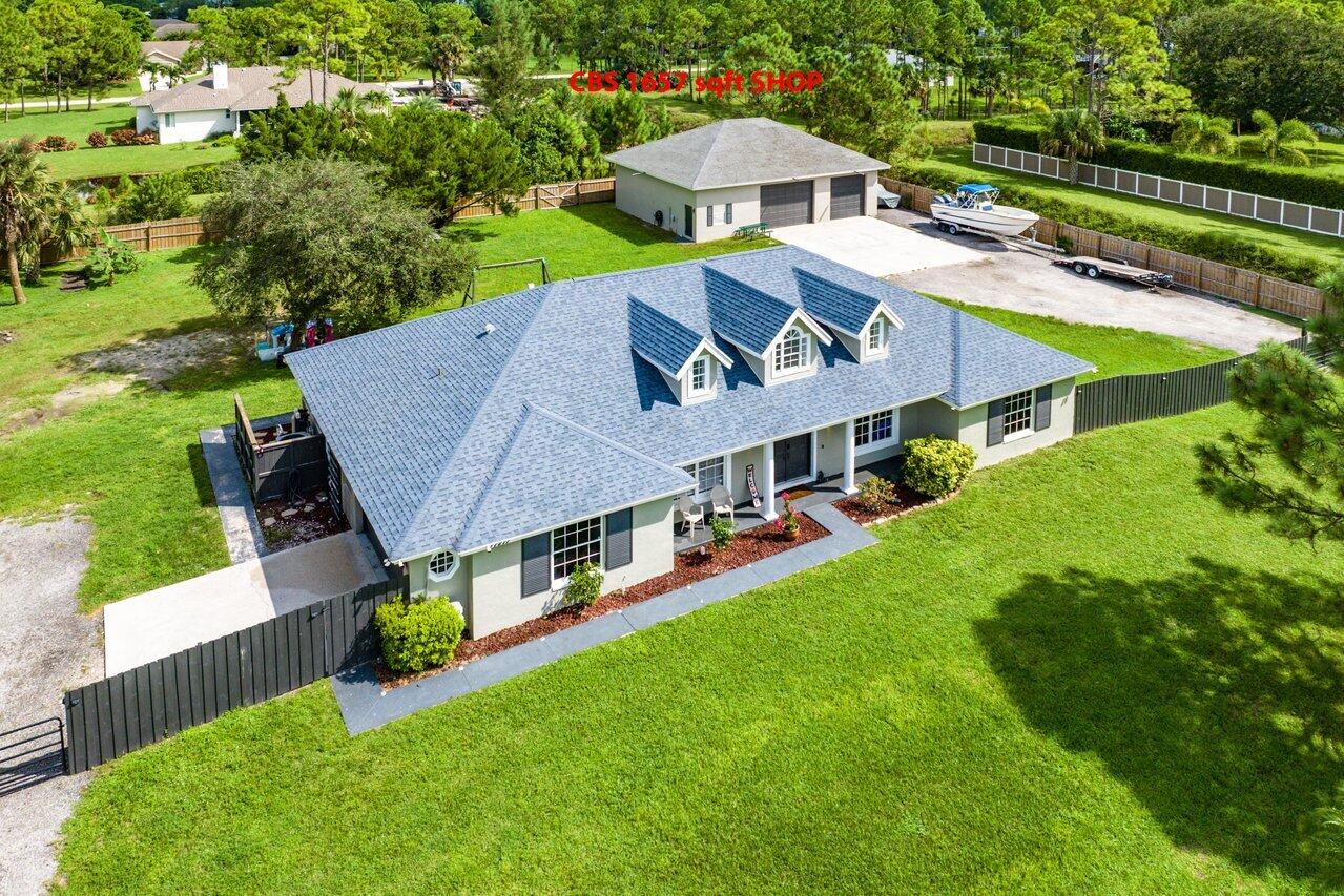 an aerial view of a house with swimming pool garden view and lake view