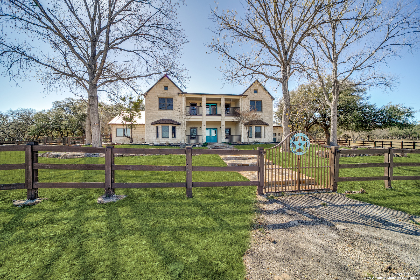 a front view of house with yard and green space