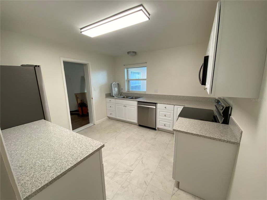 a kitchen with a sink and a refrigerator