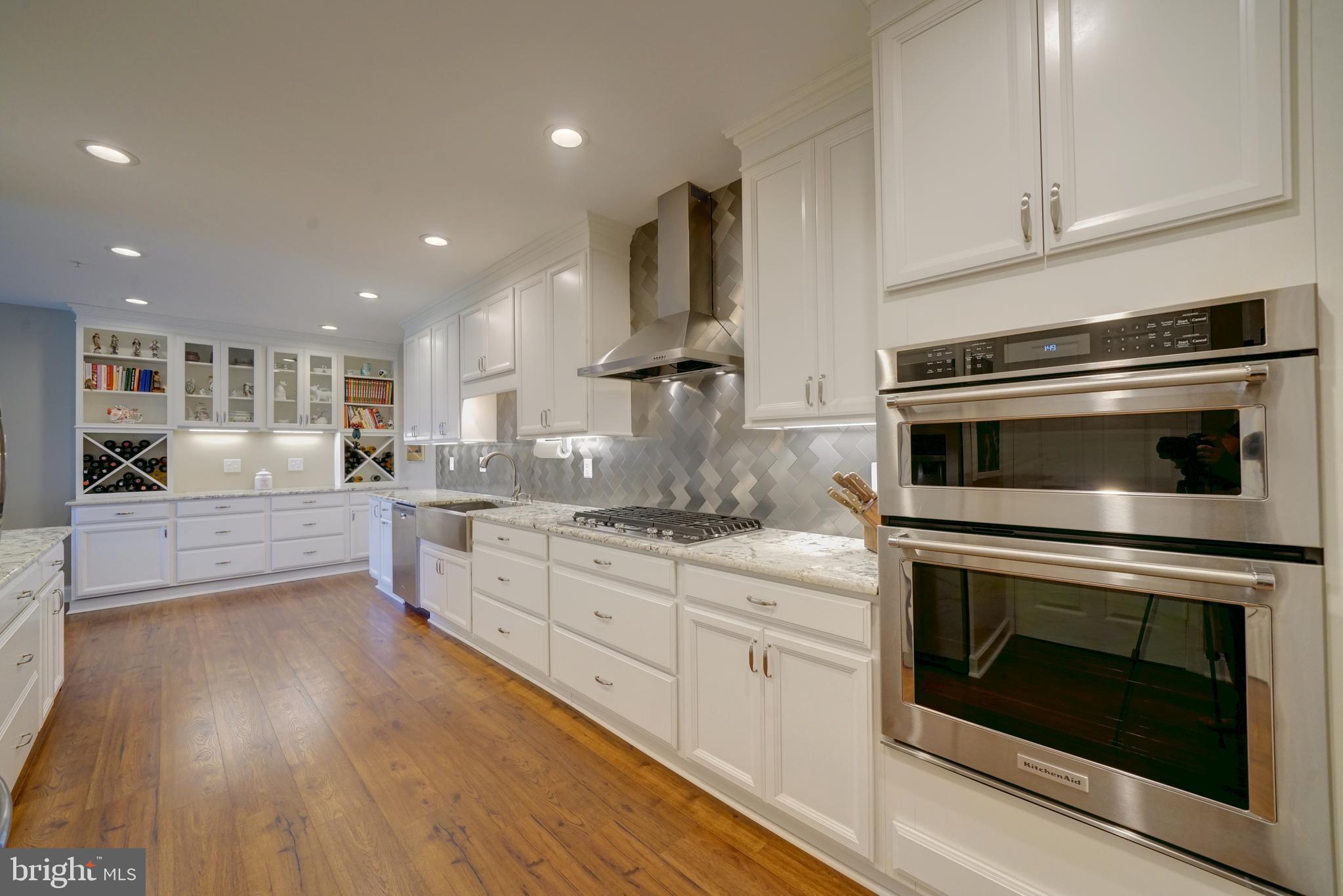 a kitchen with stainless steel appliances granite countertop a stove top oven and sink