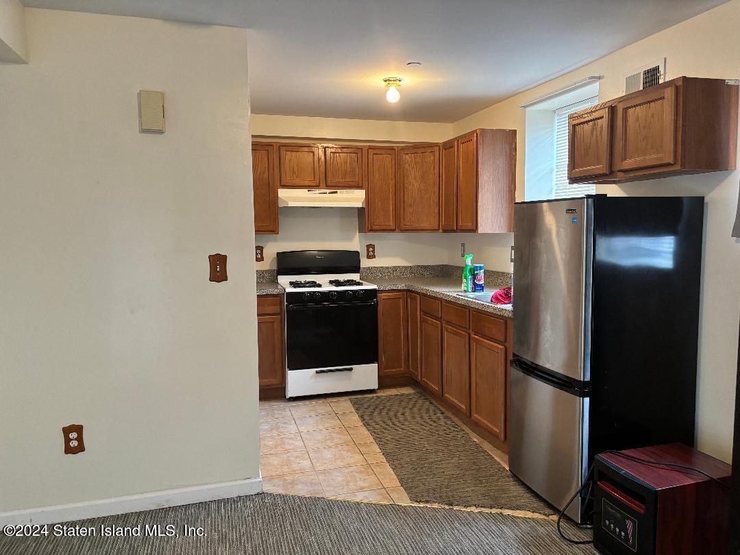 a kitchen with a refrigerator sink and stove