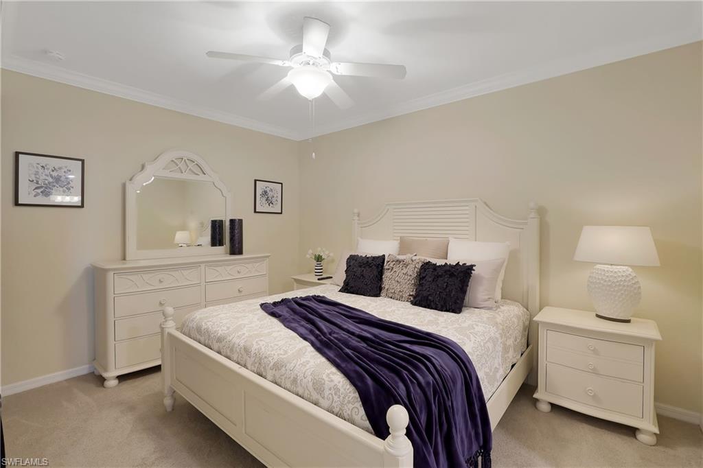 a bedroom with a white bed and a chandelier