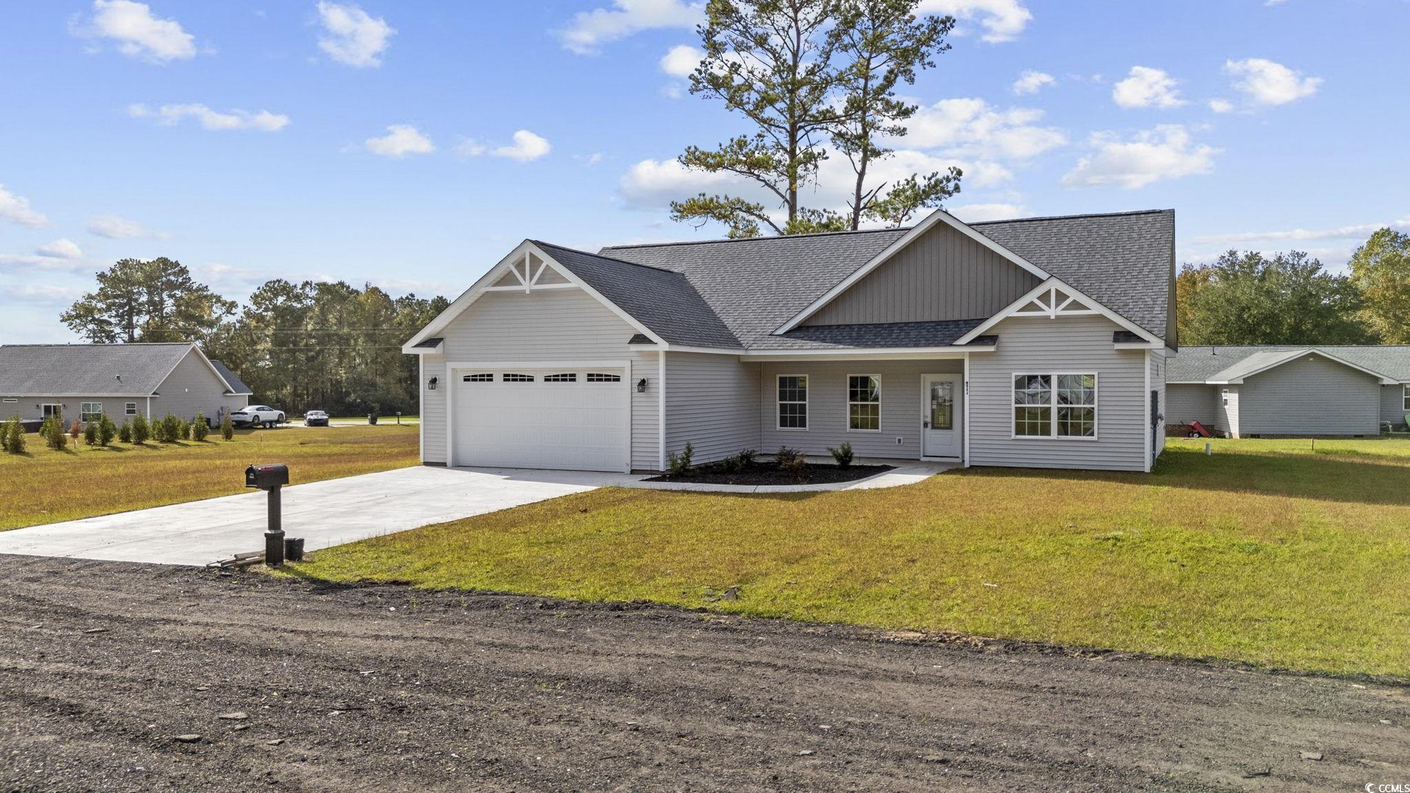 View of front of house with a garage and a front l