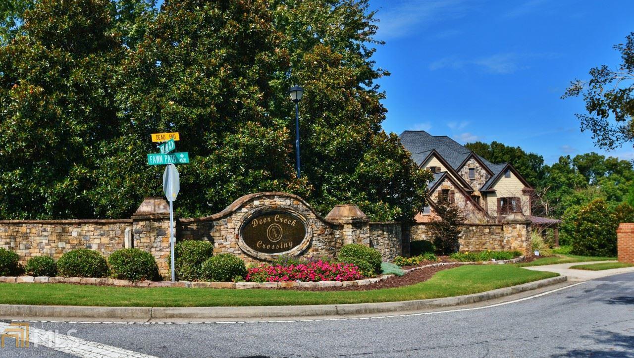 a front view of a house with yard and green space