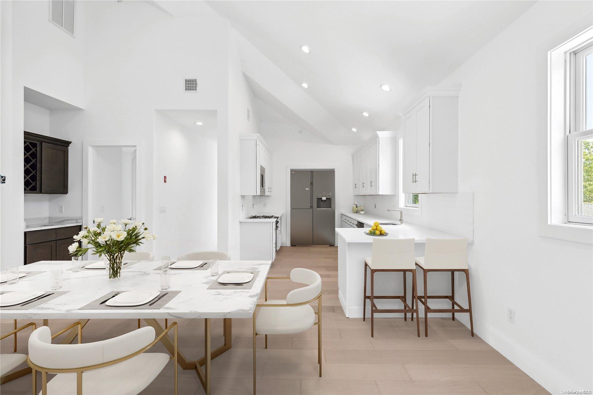 a kitchen with a dining table chairs and microwave