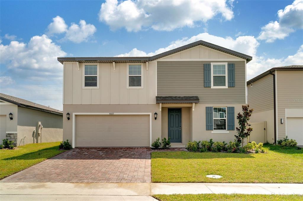 a front view of a house with a yard and garage