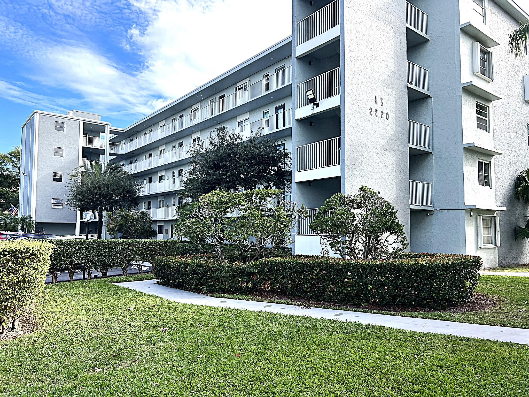 a front view of a building with a garden