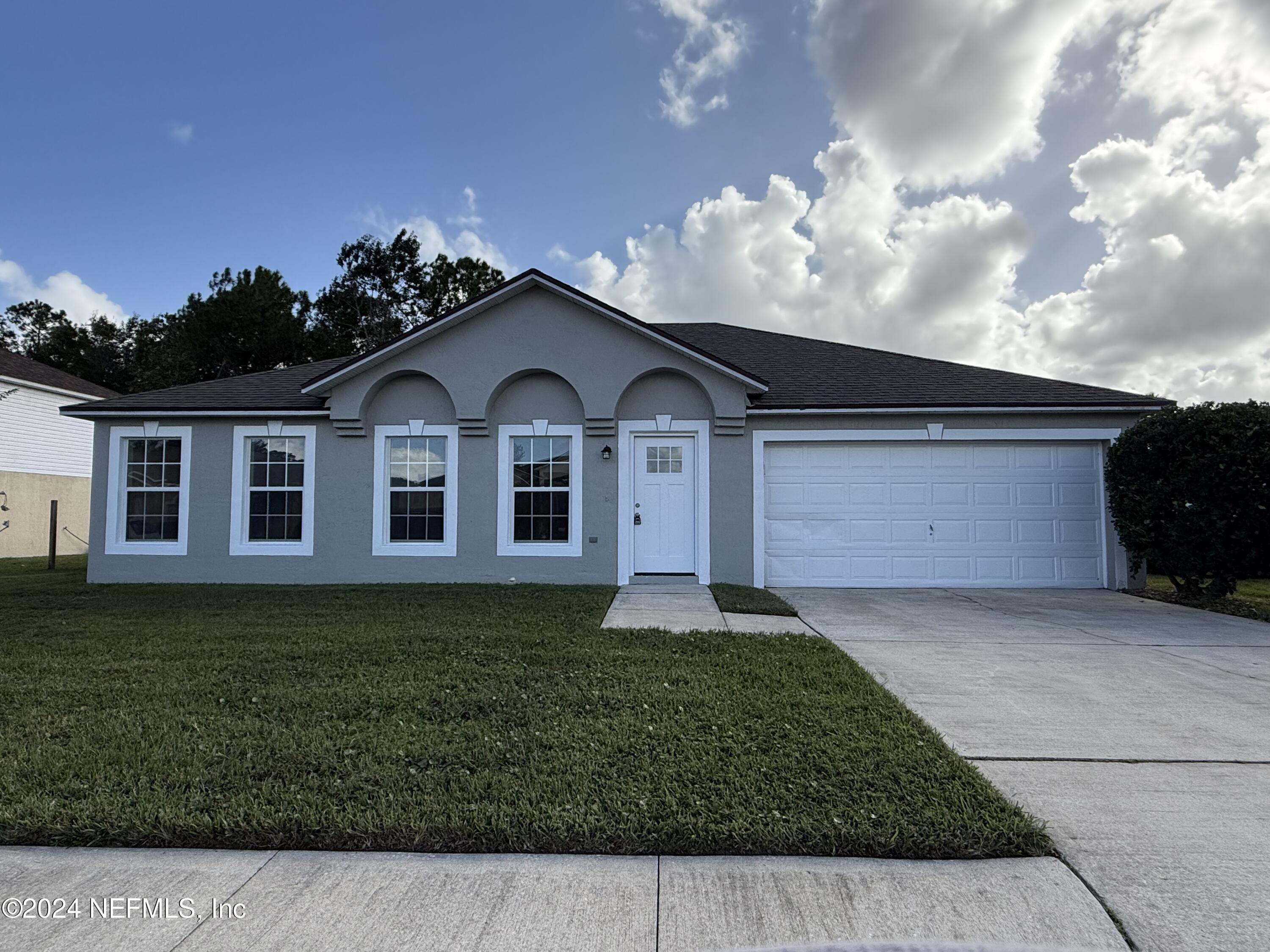 a front view of a house with a garden