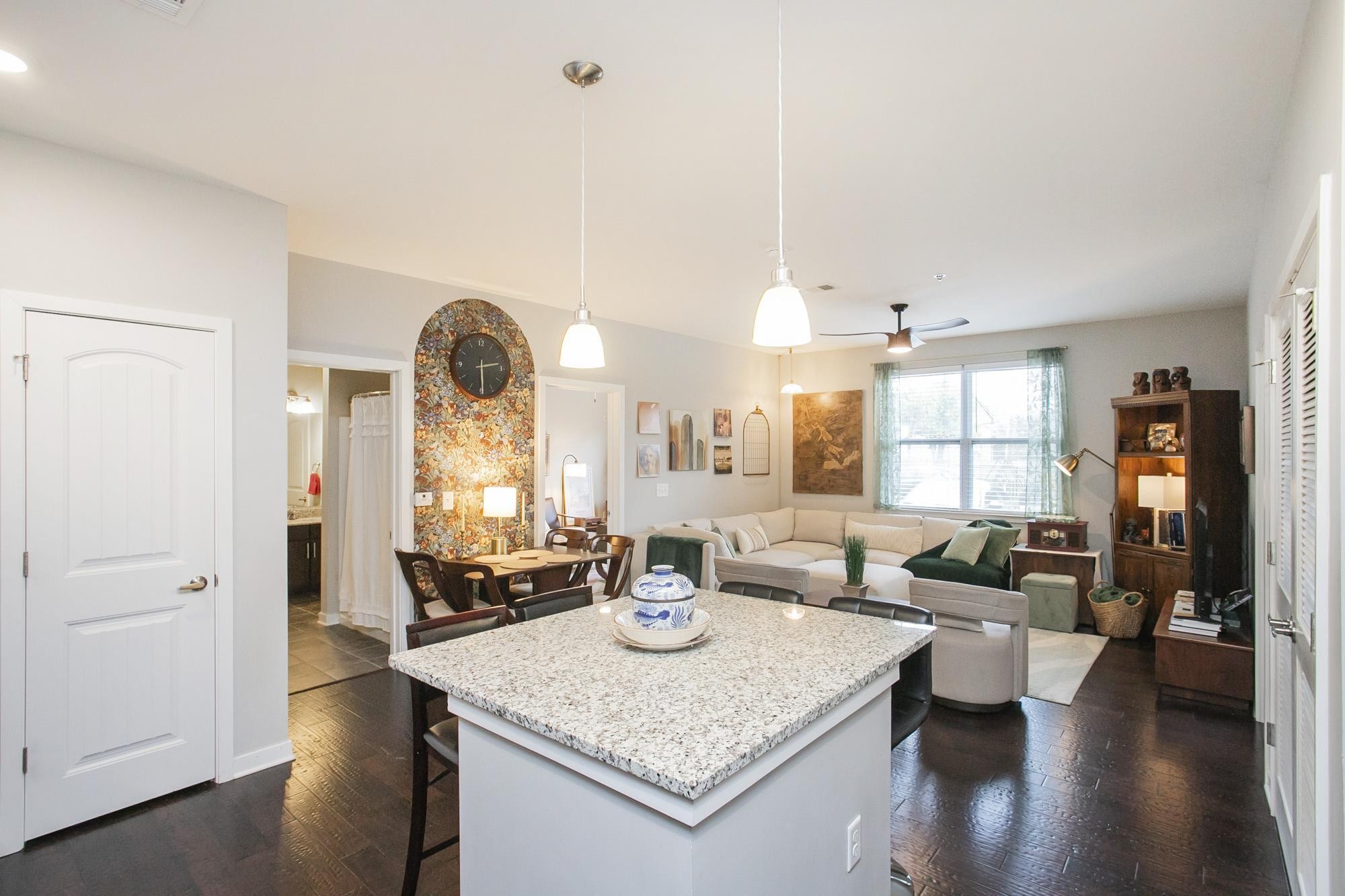 a living room with dining table and wooden floor