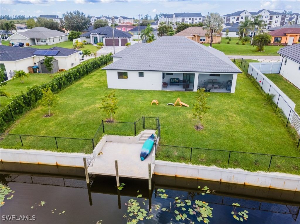 an aerial view of a house with a garden and lake view