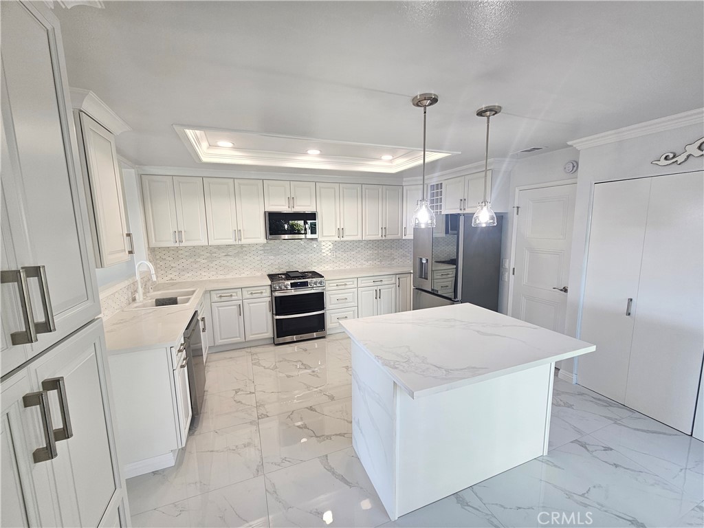 a kitchen with white cabinets and stainless steel appliances