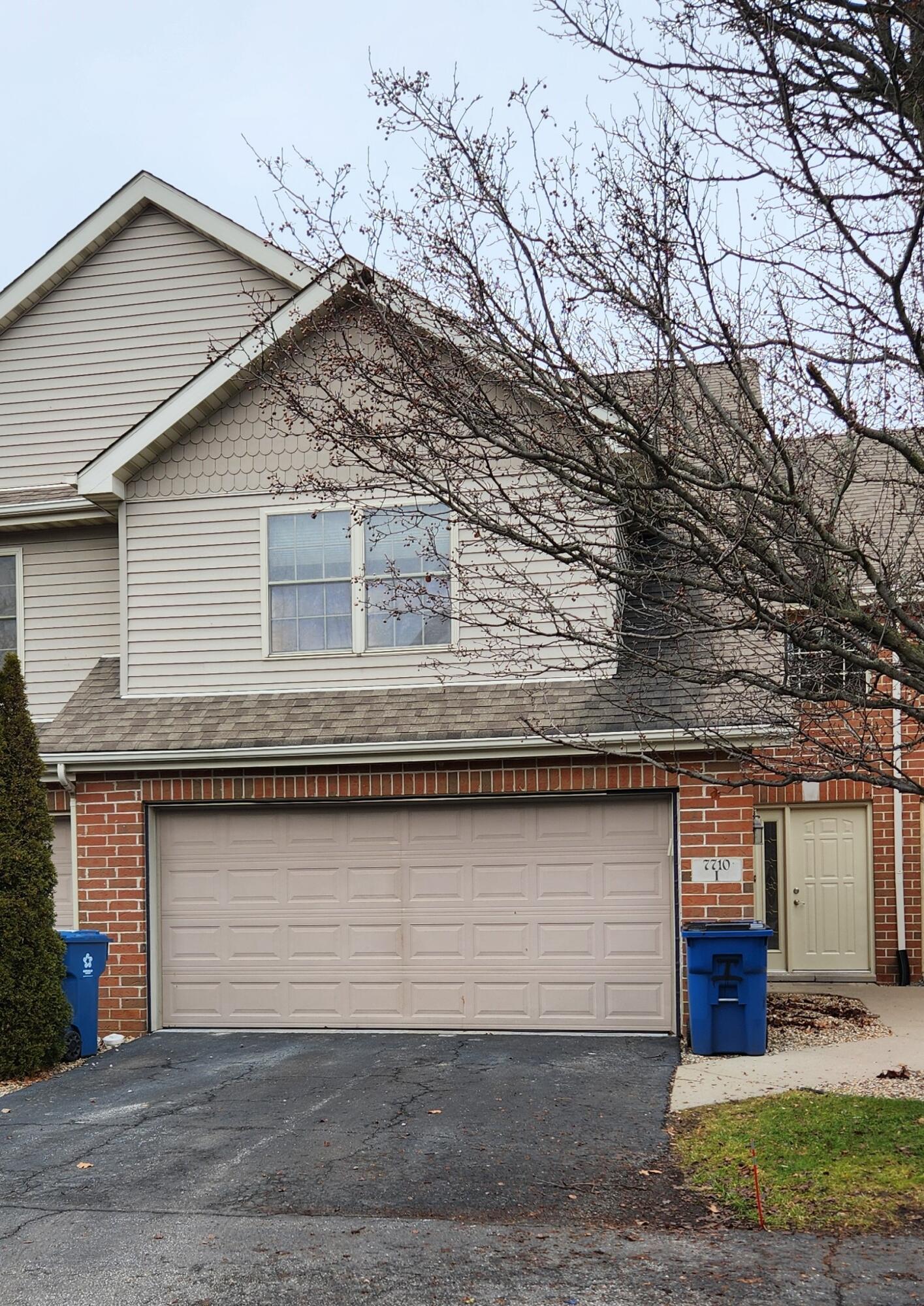 a view of a house with a yard and garage