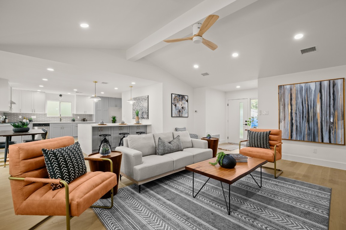 a living room with furniture kitchen view and a table