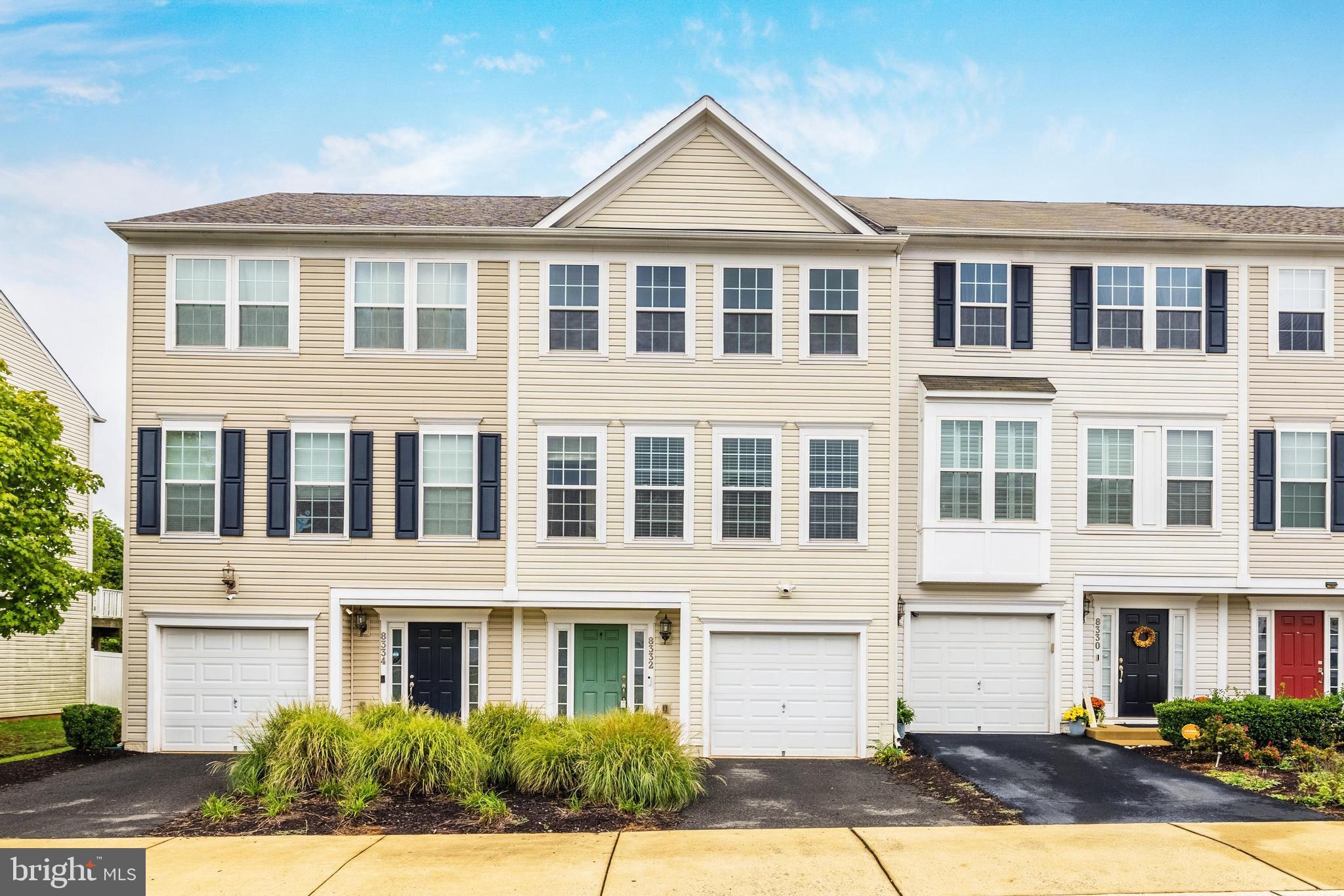 a front view of a residential apartment building with a yard