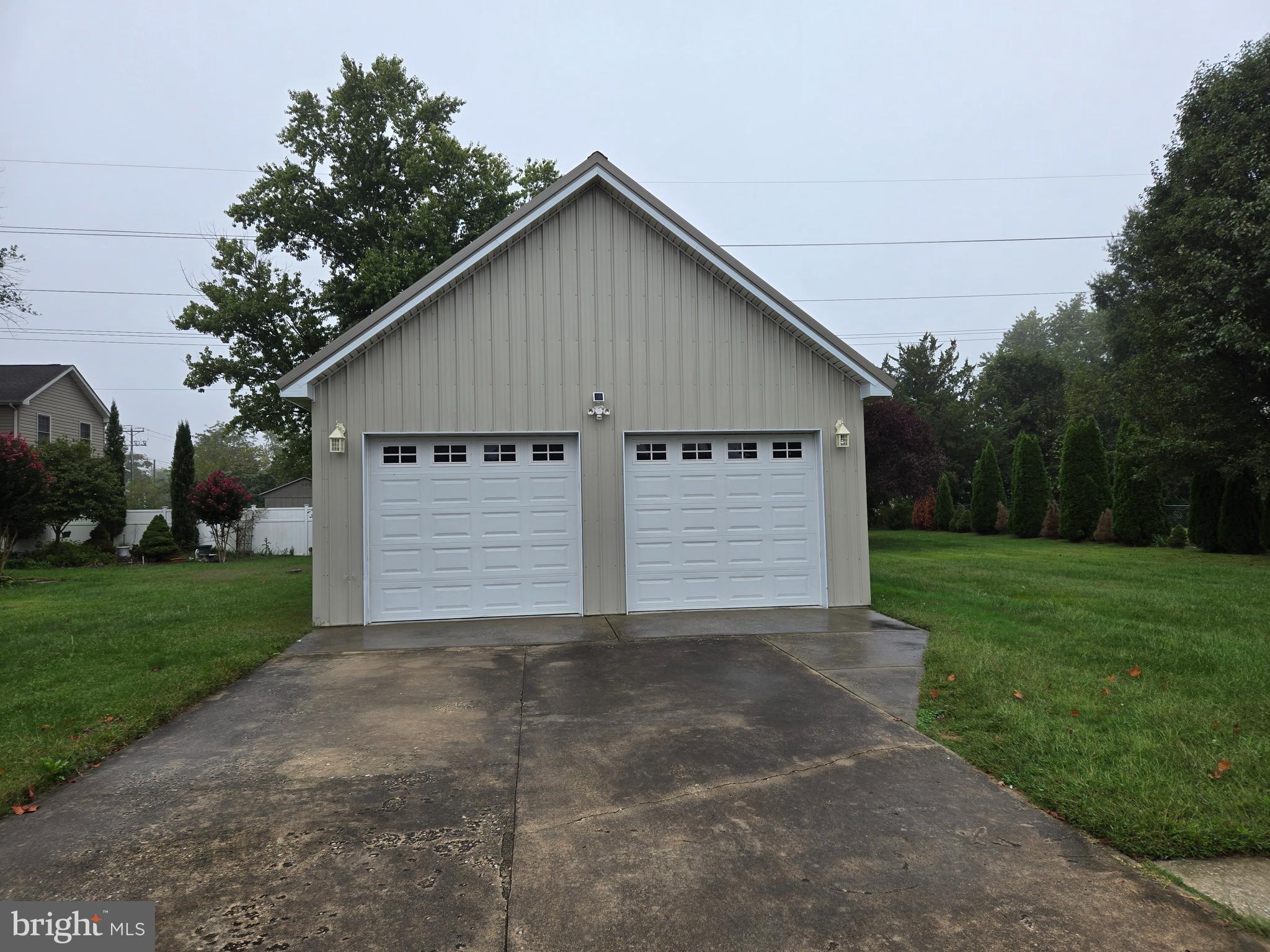 a view of a house with yard and a garage