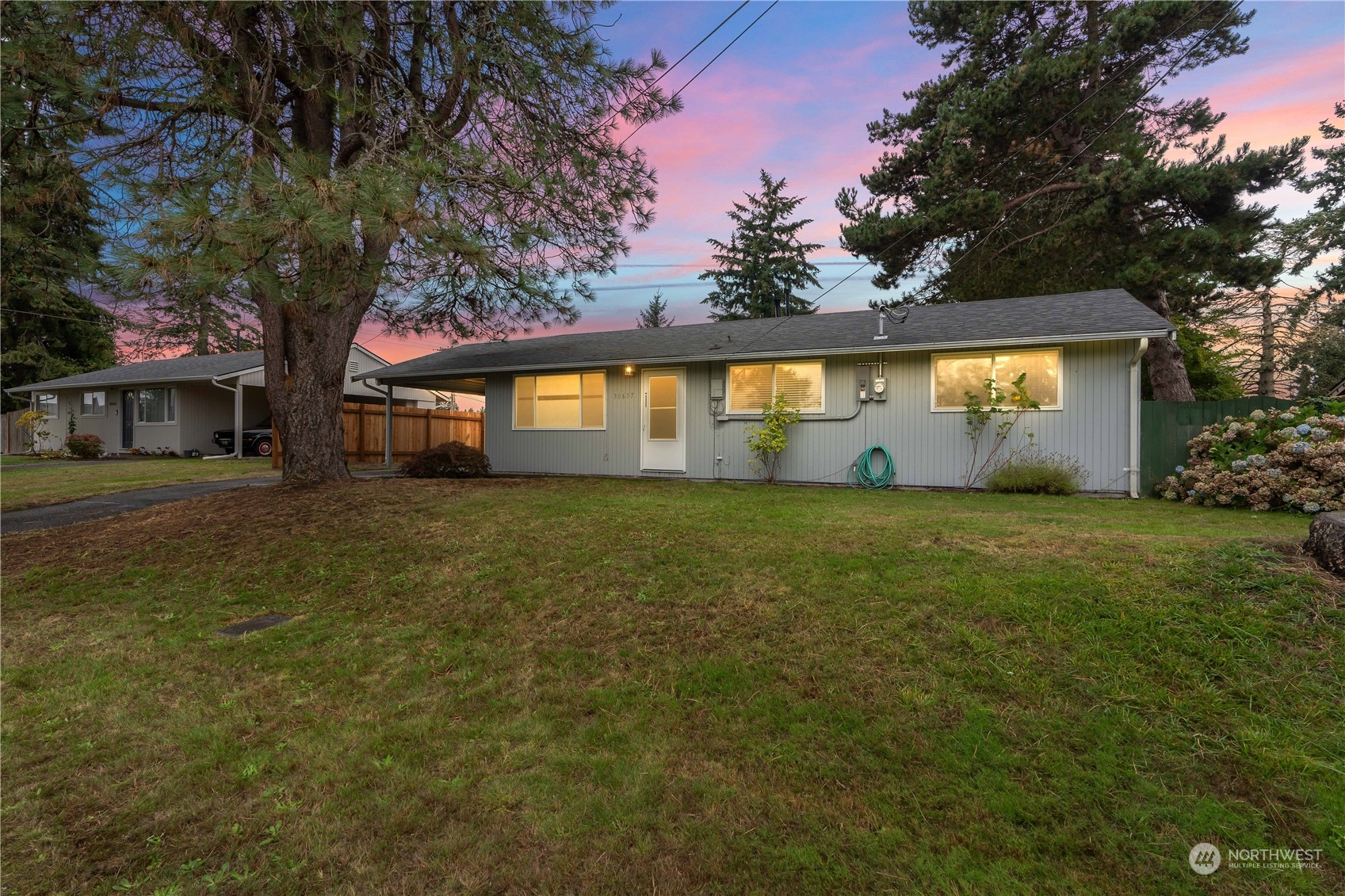 a front view of house with yard and trees around