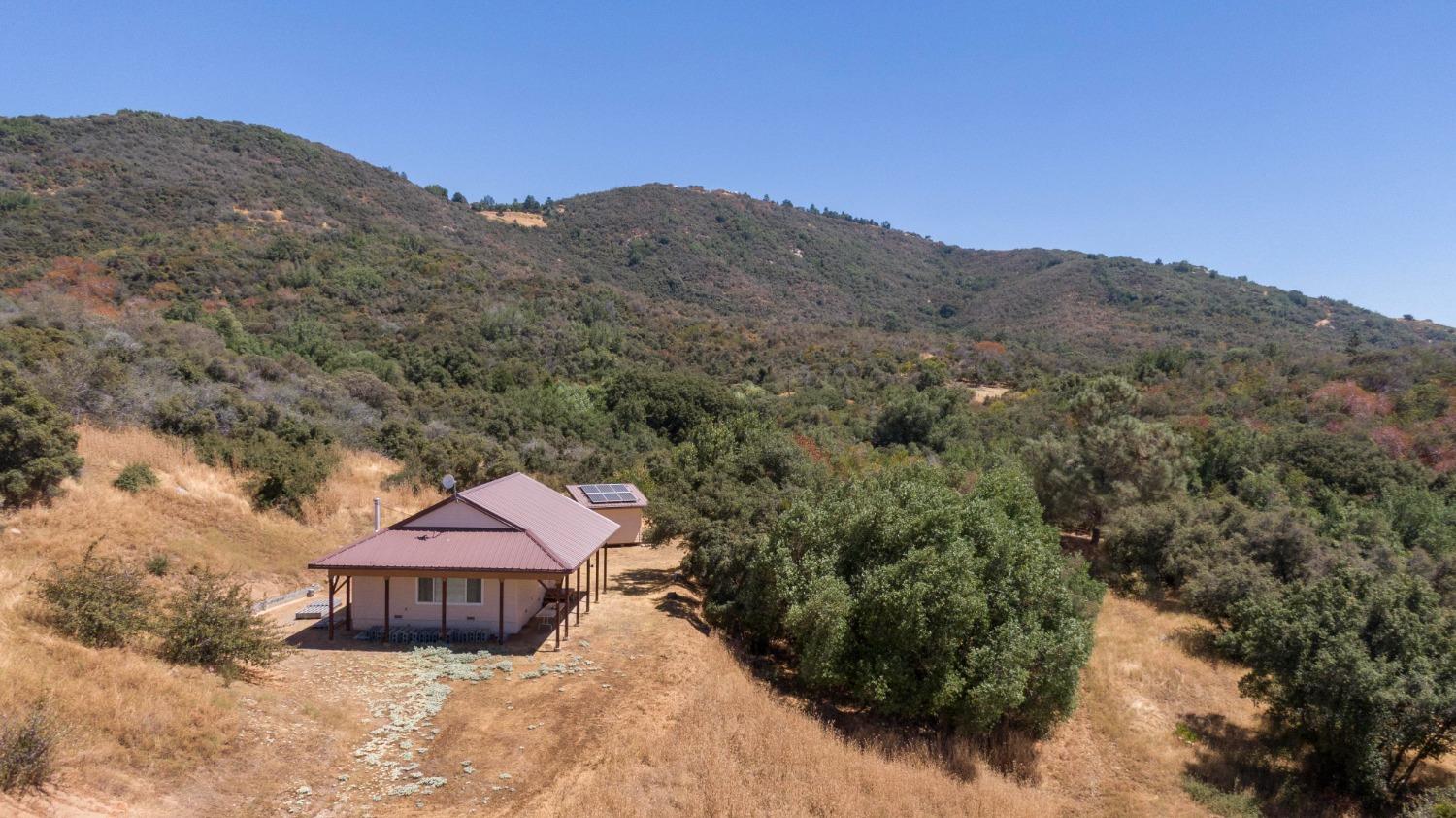 a view of a house with a mountain in the background