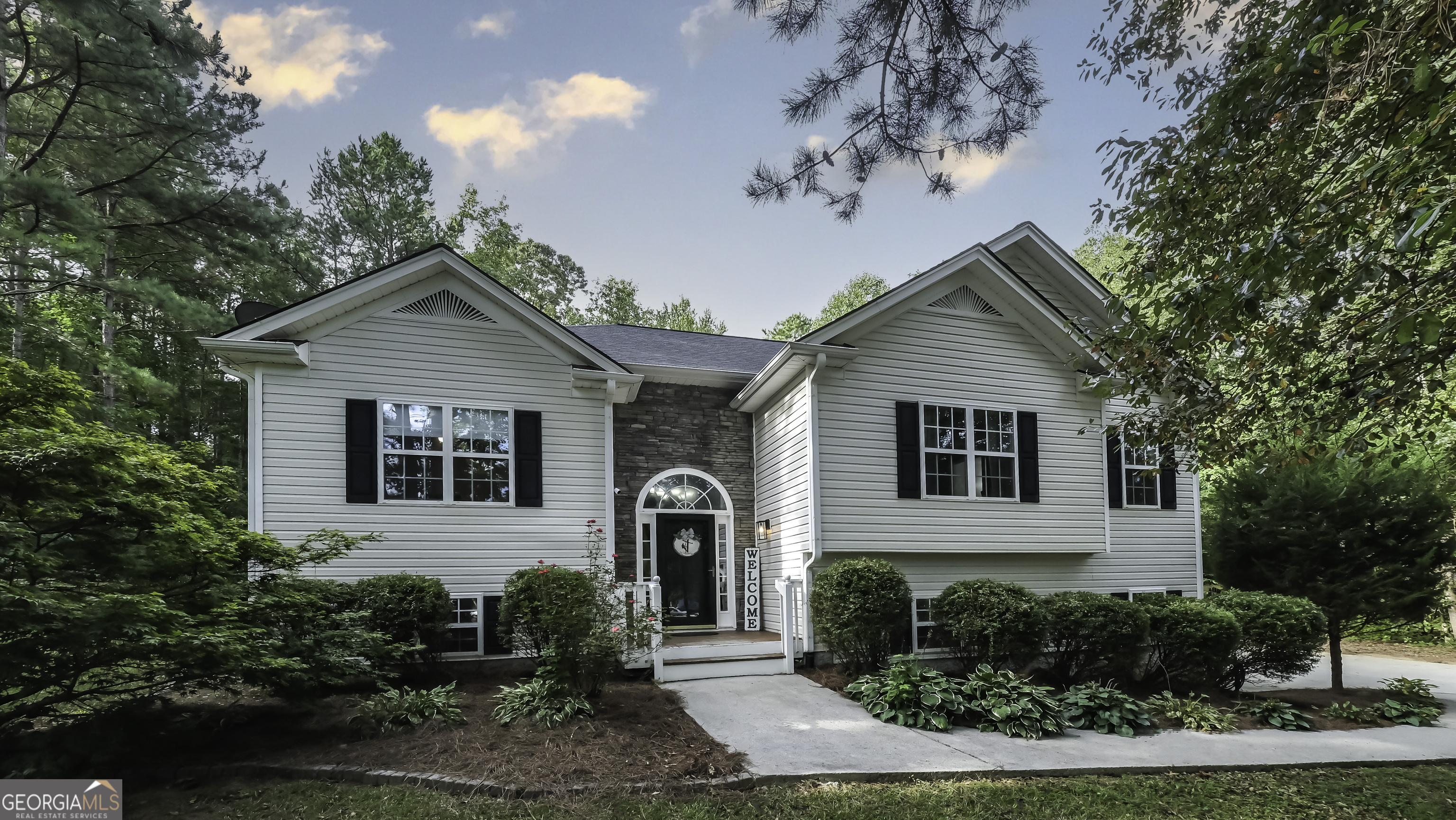 a front view of a house with garden