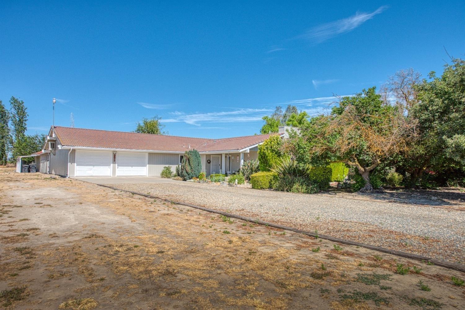 a front view of a house with a yard and a garage